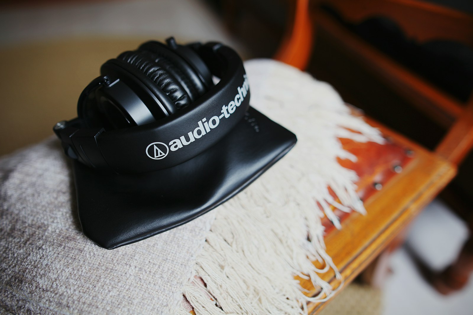 Folded black Audio-Technica headphones resting on a case.